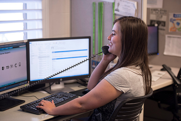 Employees work on developing a better curriculum for online students.