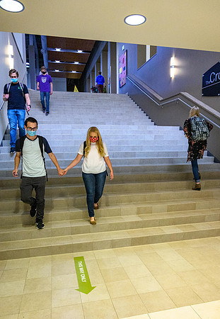 Student volunteers show the way to stay safe during this COVID 19 pandemic by social distancing, following pathway arrows and proper wearing of masks .