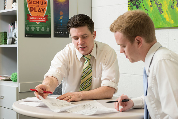 Graphic Designer, Jed Rhien mentors one of his students.