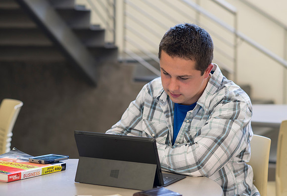 Back to Shool April 2014. Student studying in the Snow Building outside the Black Box theater.
