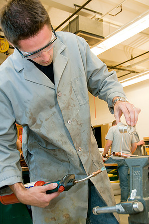 Student "sweating" a pipe in a plumbing project in Del Mortensen's Mechanical Systems class.
