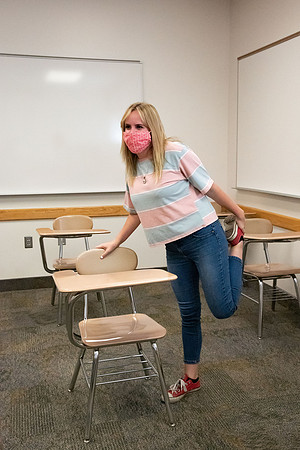 Examples of students staying safe and healthy during the COVID-19 pandemic by social distancing, following pathway arrows, and wearing face masks.