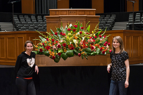 Floral Design students, Lauren Smith and Margaret Setterstrom create a beautiful floral arrangement in front of the podium for devotional.