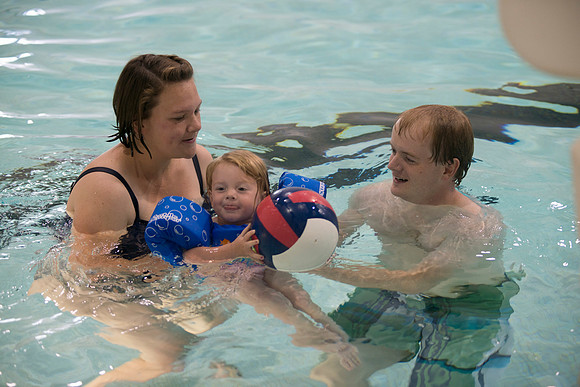 A family enjoys time together in the pool.