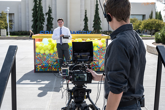 Students who volunteer to participate sit in the ball pit and ask each other questions which are found on the balloons. Video is being produced for Student Living.