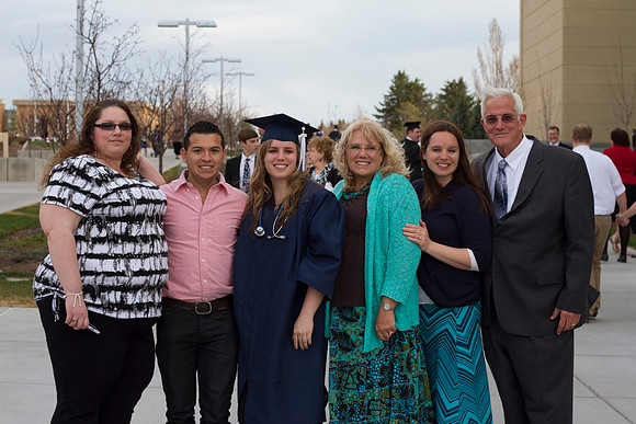 A 2014 Winter graduate smiles with her family after the Commencement Ceremony in the I-Center during the 2014 Winter Graduation.