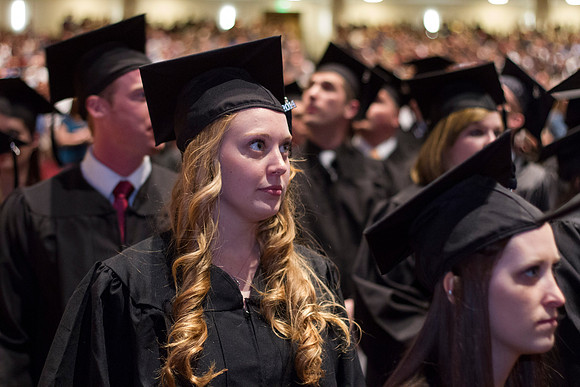 A 2014 Winter graduate looks to the front of the i-Center during the Commencement Ceremony.