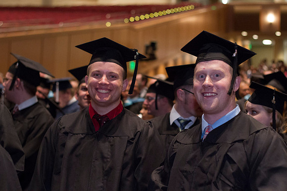 Students smile as they wait for the Commencement Ceremony to begin in the i-Center during the 2014 Winter Semester Graduation.
