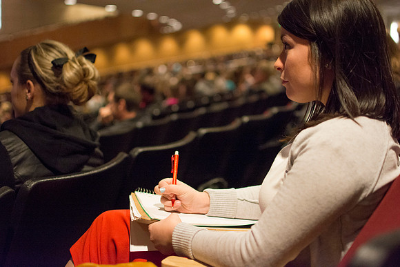 AImee Edmonds taking notes at Melodi Johnson's devotional talk