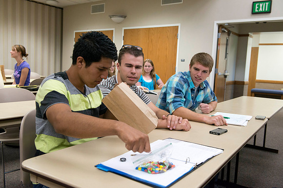 Political Science students in Brother Adamson's class participate in a hands-on activity during class.