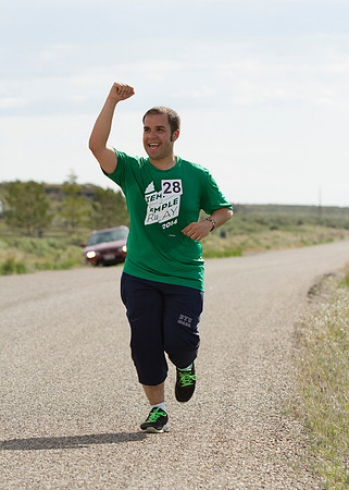 Runners participating in the Temple 2 Temple Relay run next to "Our Mountain" on the last Saturday of May, during the 2014 Spring Semester.