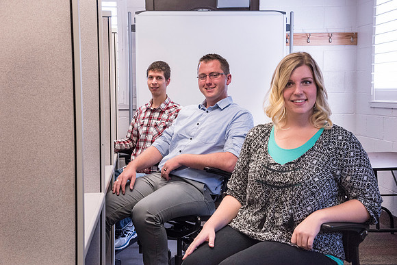 Employees work on developing a better curriculum for online students.