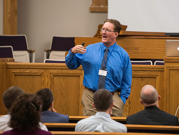 Faculty gather in the Hinckley Building for a conference to learn from their peers. Instructor Jason Dietz