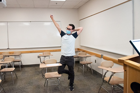 Examples of students staying safe and healthy during the COVID-19 pandemic by social distancing, following pathway arrows, and wearing face masks.