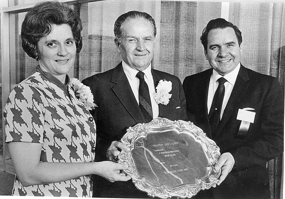 John L. Clarke served as President of Ricks College from 1944 to 1971. President Clarke recieves a Distinguished Service Award on May 6, 1971 for his years of service with his wife LaRae Clarke. Prese