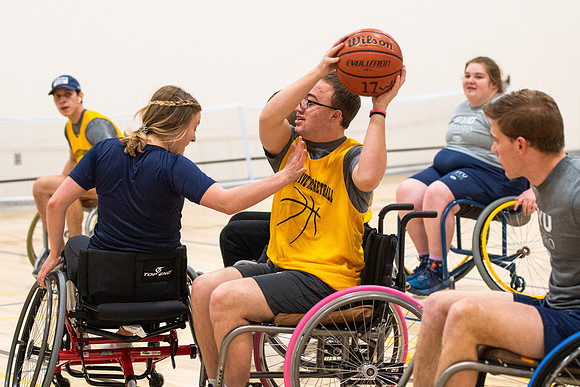 Students participate of Wheelchair Basketball in the Hart Gym.