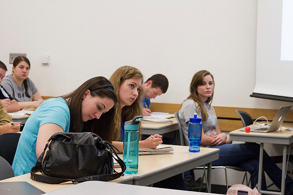 Students in Brother Yost's history class take notes during the lesson.