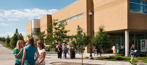 Education Week participants walking to classes held in the Thomas E. Ricks Building.