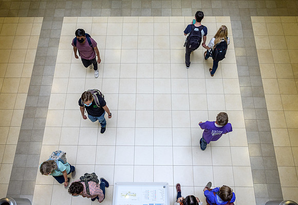 Student volunteers show the way to stay safe during this COVID 19 pandemic by social distancing, following pathway arrows and proper wearing of masks .