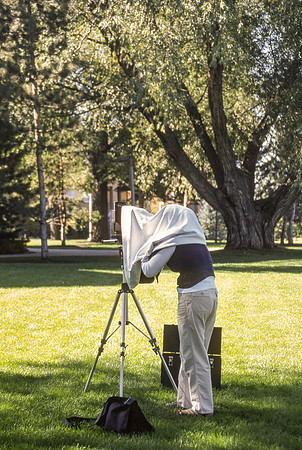 Student works outside with a large format camera.