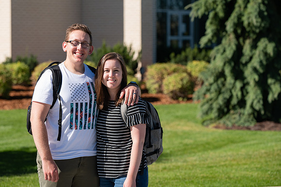 Examples of students staying safe and healthy during the COVID-19 pandemic by social distancing, following pathway arrows, and wearing face masks.
