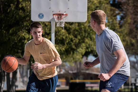 Jacob and Jacob, two BYU-Idaho students, play one on one basketball at the Smith Park court.