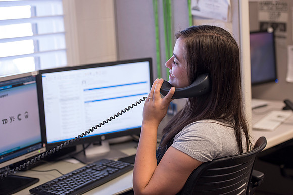 Employees work on developing a better curriculum for online students.