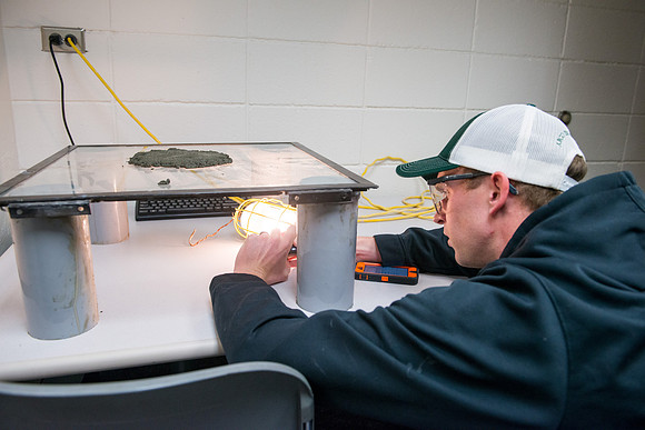 Civil engineering students work with different mixtures of cement to make a light, yet durable, cement that will be the building material for a canoe.