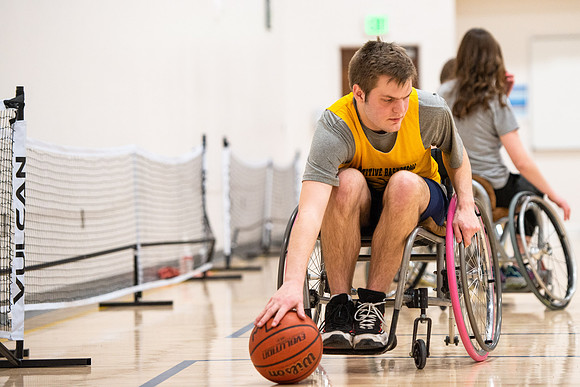 Students participate of Wheelchair Basketball in the Hart Gym.