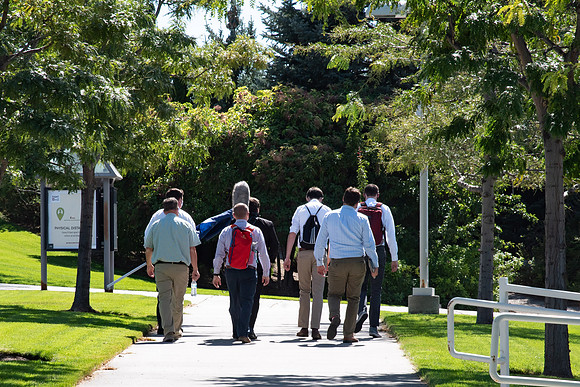 Video crew walking through campus for We're In This Together videos.