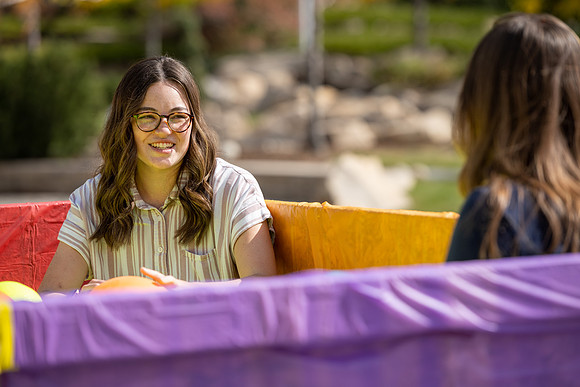 Students who volunteer to participate sit in the ball pit and ask each other questions which are found on the balloons. Video is being produced for Student Living.