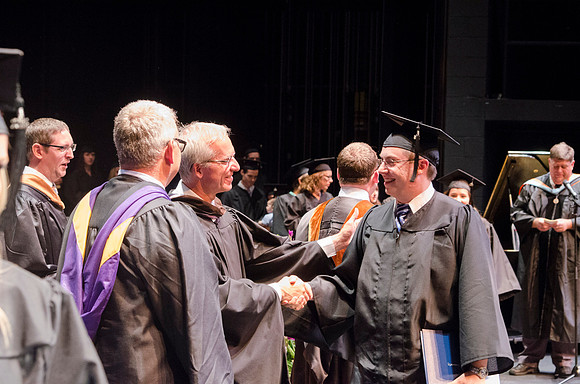 Dean's of the College of Performing and Visual Arts award diplomas to graduates during convocation held in the Snow Building.