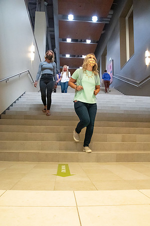 Examples of students staying safe and healthy during the COVID-19 pandemic by social distancing, following pathway arrows, and wearing face masks.