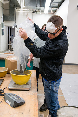 Civil engineering students work with different mixtures of cement to make a light, yet durable, cement that will be the building material for a canoe.