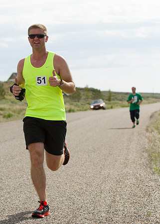 Runners participating in the Temple 2 Temple Relay run next to "Our Mountain" on the last Saturday of May, during the 2014 Spring Semester.