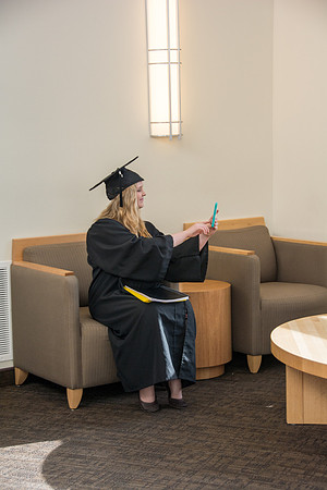 A graduate takes a selfie after the commencement ceremony. Photo by Ryan Chase