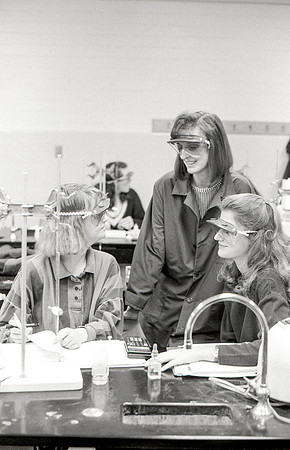 Chemistry teacher, Susan Ward, works with students during their Chemistry lab. December 1995.