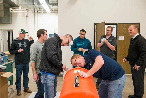 Civil engineering students work with different mixtures of cement to make a light, yet durable, cement that will be the building material for a canoe.