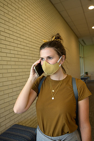 Student volunteers show the way to stay safe during this COVID 19 pandemic by social distancing, following pathway arrows and proper wearing of masks .