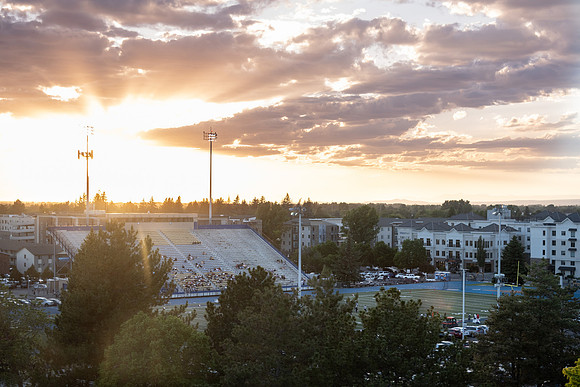 People at the Stadium during sunset for a football game