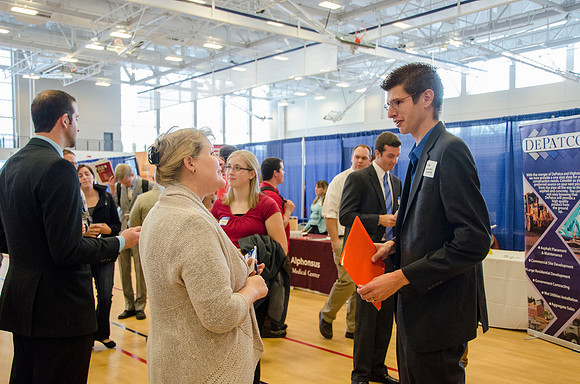BYU-Idaho students speak to representatives from colleges or companies from their field of study at a career fair held in the I-Center gym