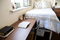 Scriptures on a desk in a clean student bedroom