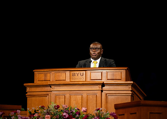 Elder Egbo speaking to students in the BYUI Center.