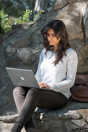 Student Noor Sofi poses in the Gardens for online learning.