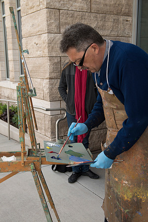 Brother Bodily gives a painting demonstration during his Oil Painting class outside the Spori Building.