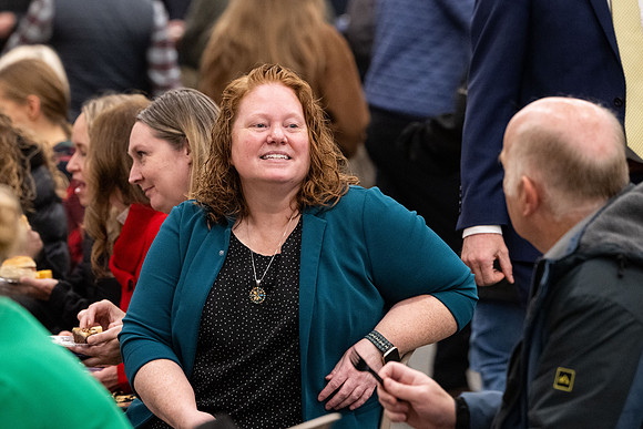 Employees gather for the annual Christmas gathering with President and Sister Meredith.