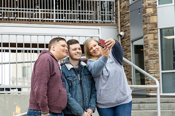 Mom taking a selfie with her two kids.
