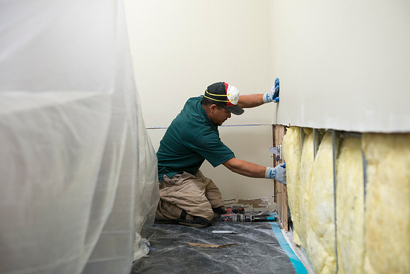 Workers from Servpro work on replacing sheetrock.