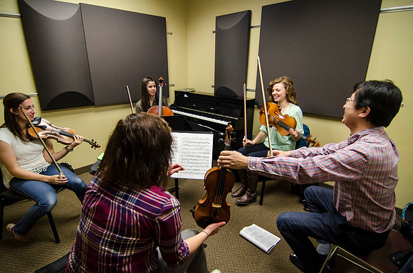 A member of the Shanghai String Quartet working with student ensembles.