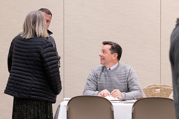 Employees gather for the annual Christmas gathering with President and Sister Meredith.